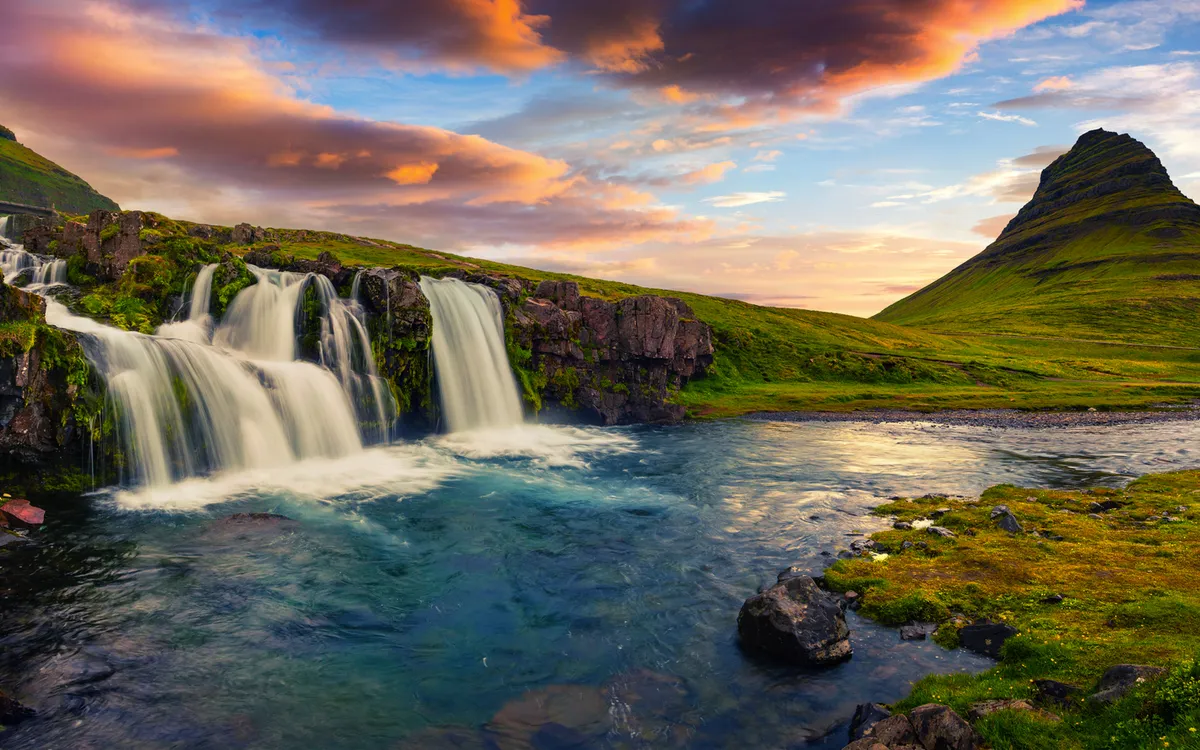 Summer sunset on famous Kirkjufellsfoss Waterfall and Kirkjufell